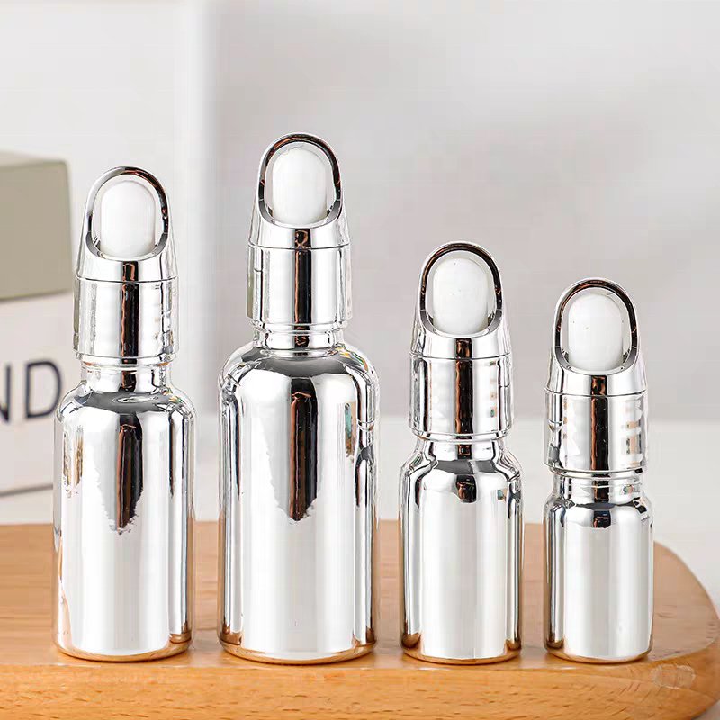 Luxury Cosmetic Packaging Essential Oil Small Round Empty Shiny Silver Dropper Oil Bottle With Unique Flower Basket Rubber