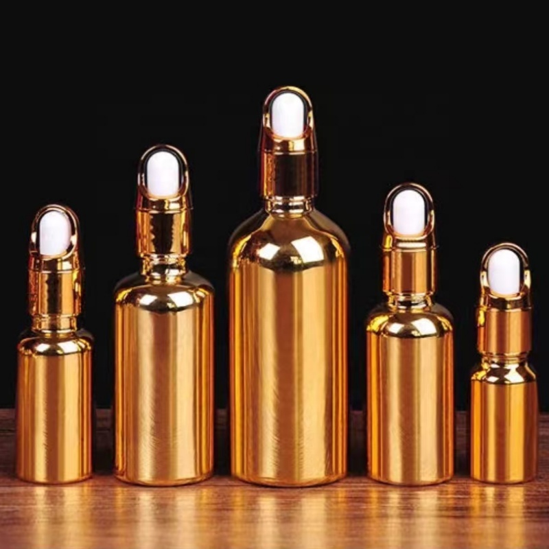 Luxury Cosmetic Packaging Essential Oil Small Round Empty Shiny Silver Gold Dropper Oil Bottle With Unique Flower Basket Rubber