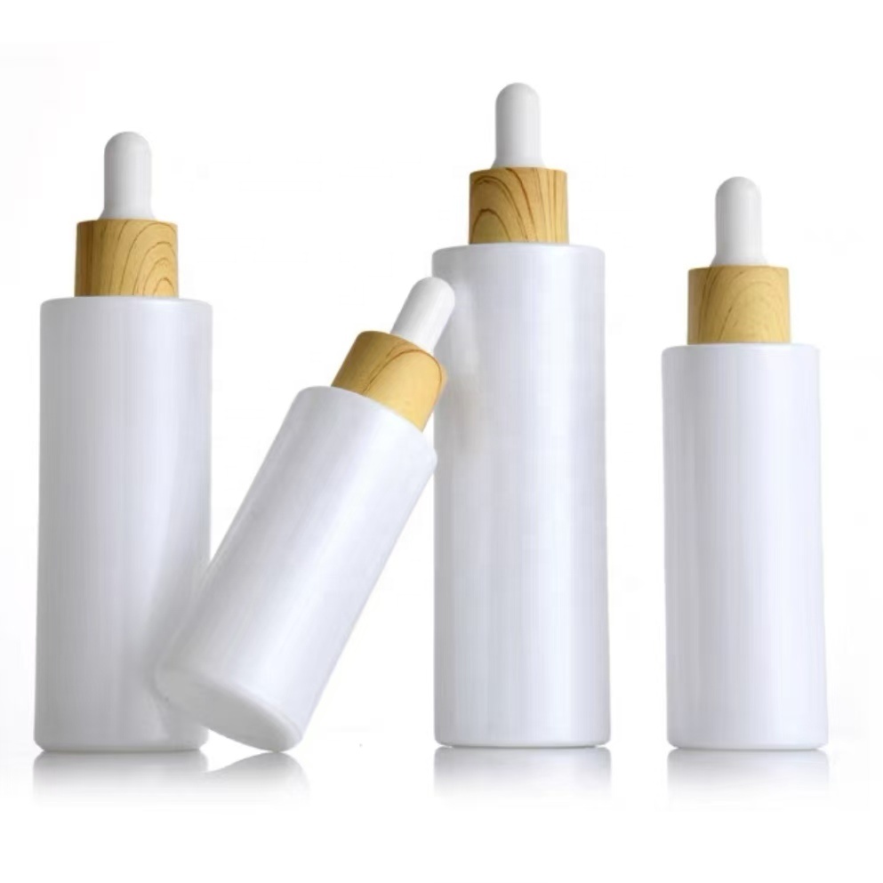 30ml 50ml 100ml Custom Pearl White Round Flat Shoulder Dropper Bottles Serum Glass Bottle With Wood Grain Cap for Essential Oil