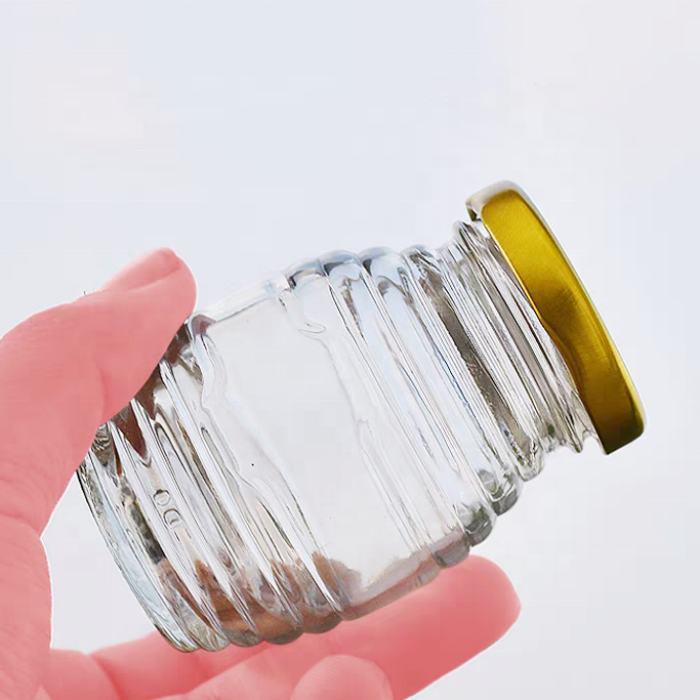 China Factory 100g 250g 500g 1000g Bee Storage Pot Container Thread Shaped Honey Jars Honeycomb Shaped Glass Honey Jars