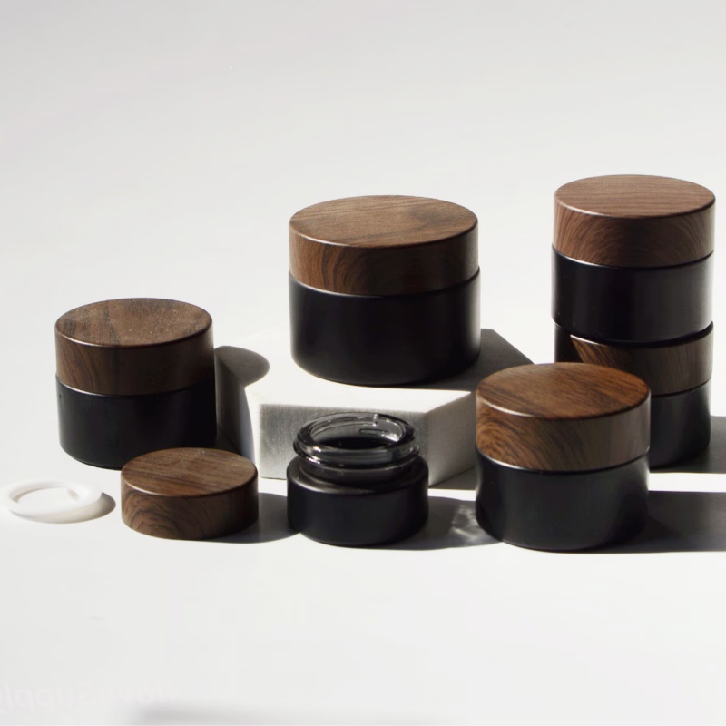 In Stock Wholesale 5/10/15/20/30/50g Matte Black Face Cream Jar Containers 1 2 4 Oz Glass Jars With Plastic Wood Grain Lid