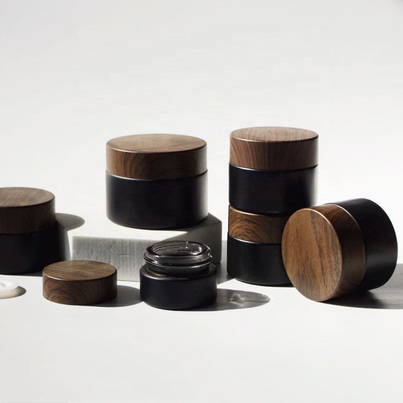 In Stock Wholesale 5/10/15/20/30/50g Matte Black Face Cream Jar Containers 1 2 4 Oz Glass Jars With Plastic Wood Grain Lid